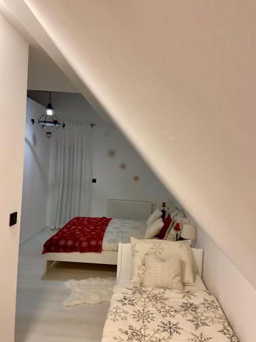a bedroom with a bed with a red blanket at Farmhouse Dzeni in Vlasic