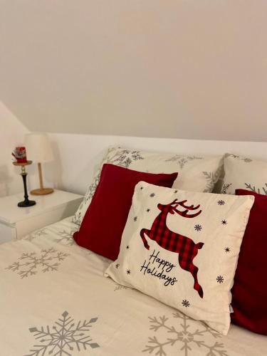 a bed with a christmas pillow on it at Farmhouse Dzeni in Vlasic