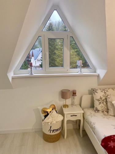 a room with a window and a bed and a table at Farmhouse Dzeni in Vlasic