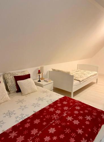 a bedroom with a bed with a red blanket at Farmhouse Dzeni in Vlasic