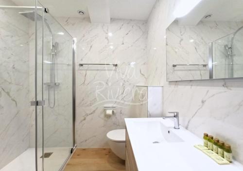 a bathroom with a shower and a sink and a toilet at Viva Riviera - Villa Royale in Cannes