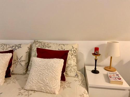 a bedroom with a bed with pillows and a lamp at Farmhouse Dzeni in Vlasic