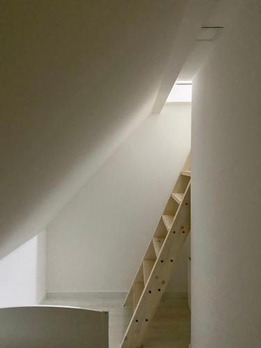 a staircase in a house with white walls at Farmhouse Dzeni in Vlasic