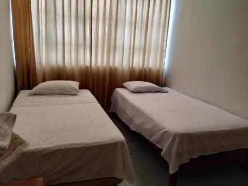 A bed or beds in a room at Gera Guest House