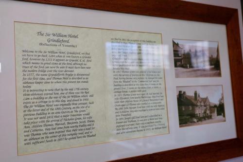 a framed picture of a picture of a house at Sir William Hotel in Grindleford Bridge