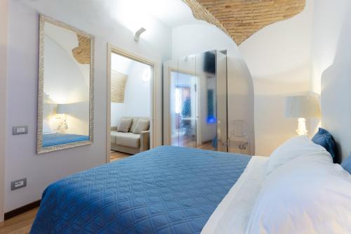 a bedroom with a blue bed and a mirror at Stella Maris suite relax in Termoli