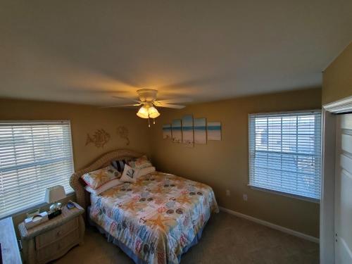 a bedroom with a bed and a ceiling fan at Family Friendly Beach Block Ocean View 3 BR, 2 BA, Condo near Wildwood Crest and Convention Center in Wildwood