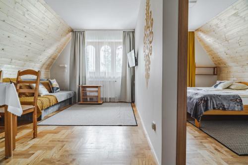 a bedroom with two beds and an attic at Gontyna in Zakopane