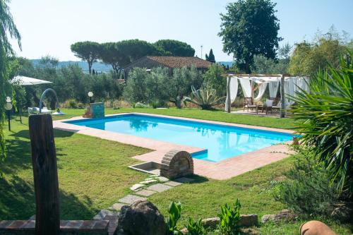 a swimming pool in the yard of a house at Agriturismo Colle Vento in Suvereto