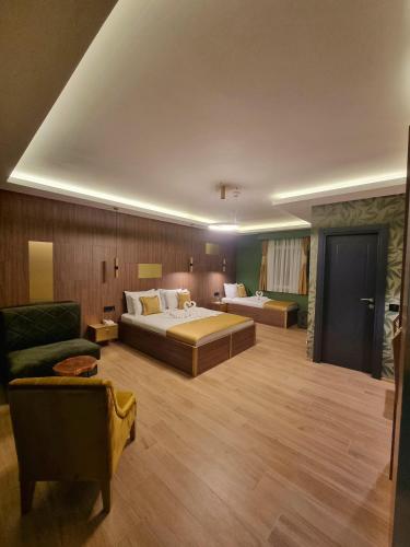 a hotel room with two beds and a couch at Dream House Hotel & Spa in Kolašin