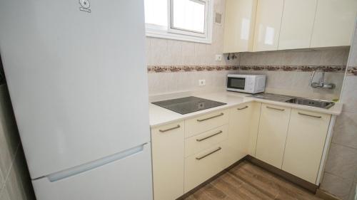 una cucina con un frigorifero bianco e un lavello di Europa 400 a Maspalomas