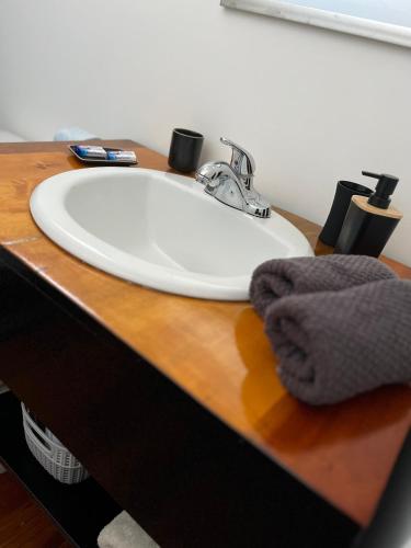 a white bathroom sink with a towel on a counter at DreamCabanas in Caye Caulker