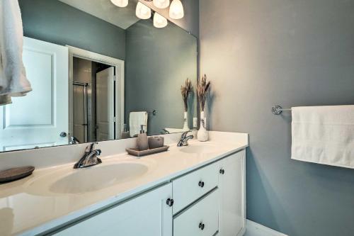 a bathroom with a sink and a mirror at Patio and Pool Access Rehoboth Beach Retreat in Rehoboth Beach