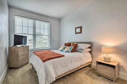 a bedroom with a bed and a tv and a window at Rehoboth Beach Vacation Rental with Porch! in Rehoboth Beach