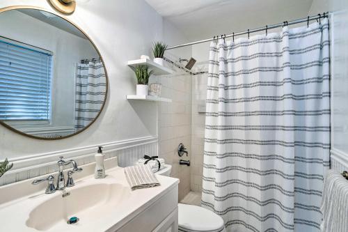 a white bathroom with a sink and a mirror at Bright Boynton Beach Getaway with Patio! in Boynton Beach