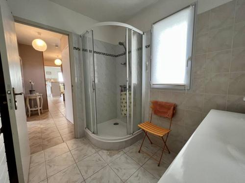 a bathroom with a shower and a chair in it at Appartement Cambo-les-Bains, 2 pièces, 2 personnes - FR-1-495-58 in Cambo-les-Bains