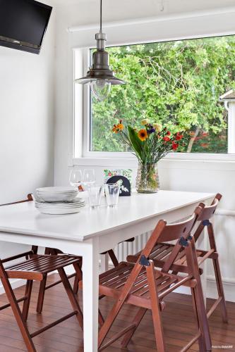 a white table and chairs in a kitchen with a window at First Camp Mölle-Höganäs in Mölle