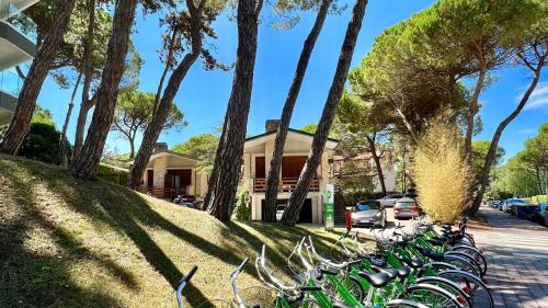 a row of bikes parked in front of a house at Hotel President in Lignano Sabbiadoro