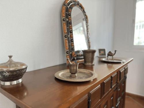 a wooden dresser with a mirror and a plate on it at House with private pool in central Mijas Pueblo in Mijas