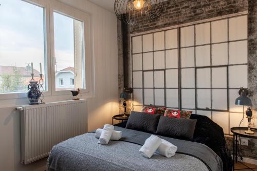 a bedroom with a bed with two pillows on it at DIFY Industriel - Parilly in Vénissieux