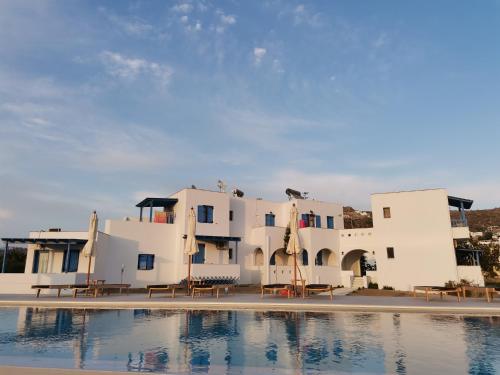 a building with a pool in front of it at Amodari studios on the beach in Plaka