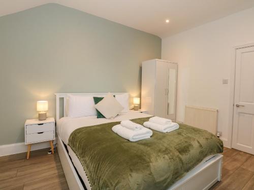a bedroom with a bed with two towels on it at Sea Breeze Apartment No 7 in Hunstanton