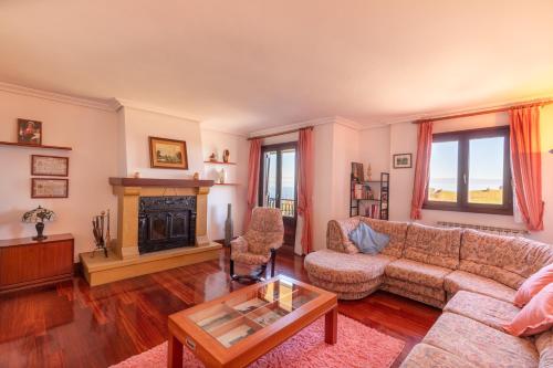 a living room with a couch and a fireplace at Casa Rural Zelaieta BerriBi in Itziar