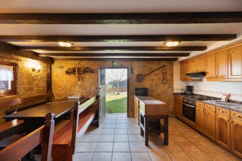 a kitchen with wooden cabinets and a counter top at Casa Rural Zelaieta BerriBi in Itziar