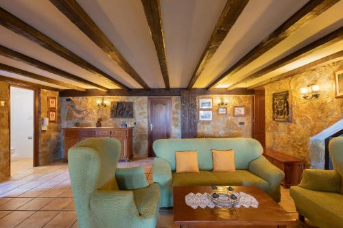 a living room with blue chairs and a table at Casa Rural Zelaieta BerriBi in Itziar