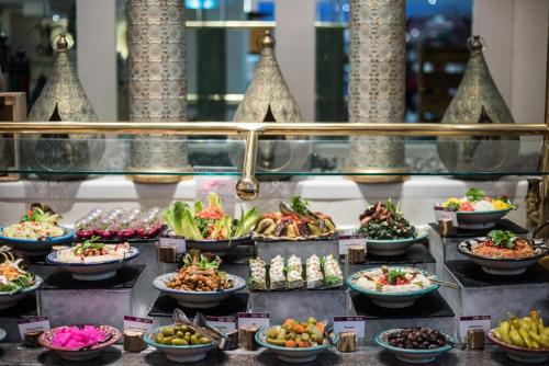 a buffet line with many different types of food at Millennium Plaza Downtown, Dubai in Dubai