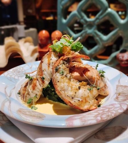 a white plate with shrimp on a table at Millennium Plaza Downtown, Dubai in Dubai