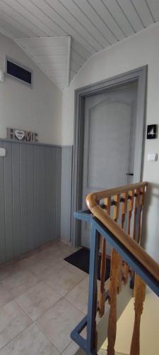 a room with a wooden railing and a door at Silence Apartmanház Zalakaros in Zalakaros