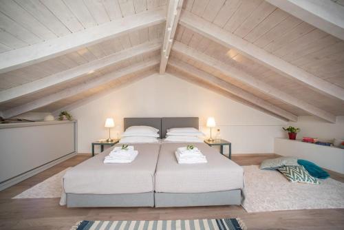 a bedroom with two beds in a attic at Newly Renovated 1730's Venetian Loft (02) ! in Corfu