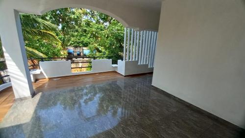 an empty living room with an archway in a house at Navam in Jaffna
