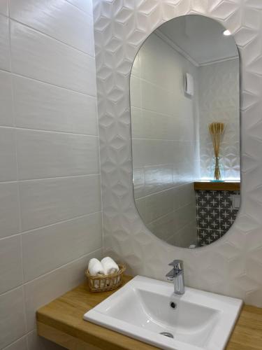 a bathroom with a sink and a mirror at UGRAD family in Slavske