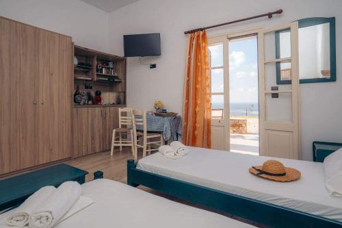 two beds in a room with a view of the ocean at Oniropagida in Apollonia