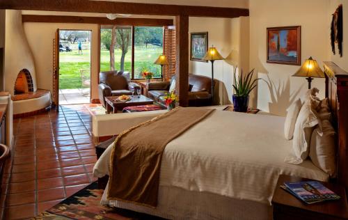 a bedroom with a large bed and a living room at Tubac Golf Resort & Spa in Tubac
