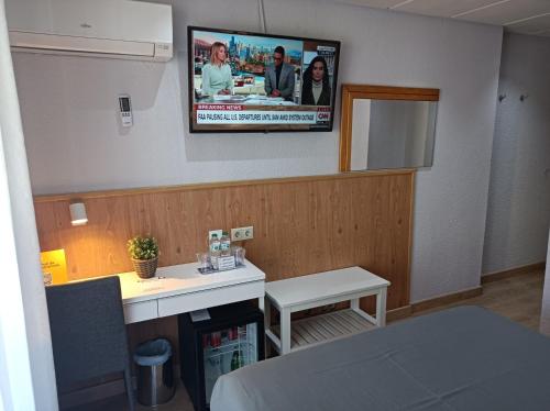 a room with a tv hanging on the wall at Mendez Nuñez Alicante in Alicante