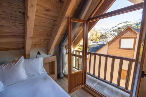 a bedroom with a bed and a large window at WOW views next to the ski lift! in Baqueira-Beret
