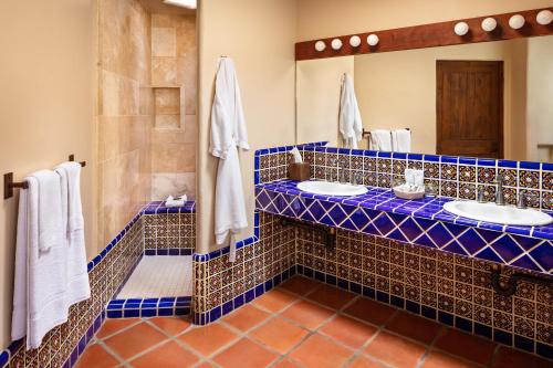 a bathroom with two sinks and a mirror at Tubac Golf Resort & Spa in Tubac