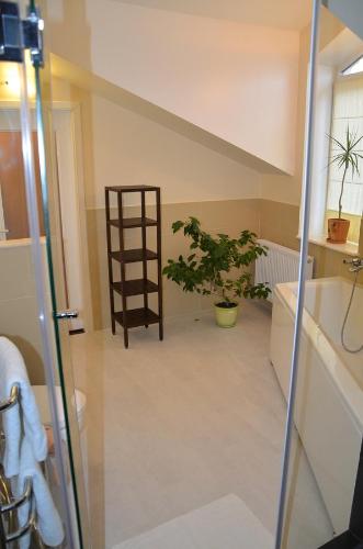 a bathroom with a plant in the corner of a room at Hotel MP in Lviv