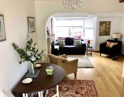 a living room with a table and a couch at Best location in town, it is all on the doorstep. in Ayr