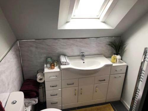 a bathroom with a sink and a window at Best location in town, it is all on the doorstep. in Ayr