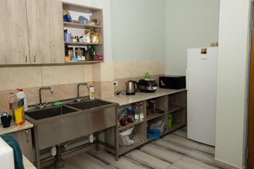 a kitchen with a sink and a refrigerator at Your home in Brody