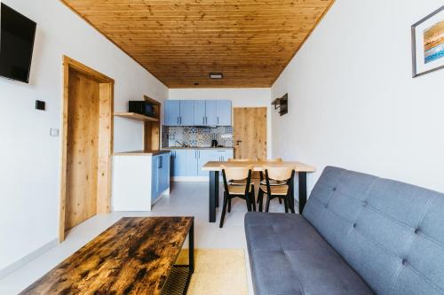 a living room with a couch and a table at Pod humnama in Krumvíř