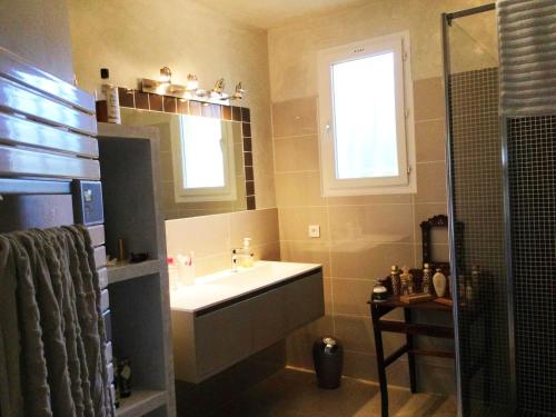 a bathroom with a sink and a window and a shower at Villa Roccu in Borgo