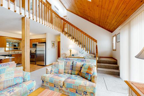 a living room with a couch and a staircase at Gull's Nest --- 39638 S Gulls Way Ct in Bethany Beach