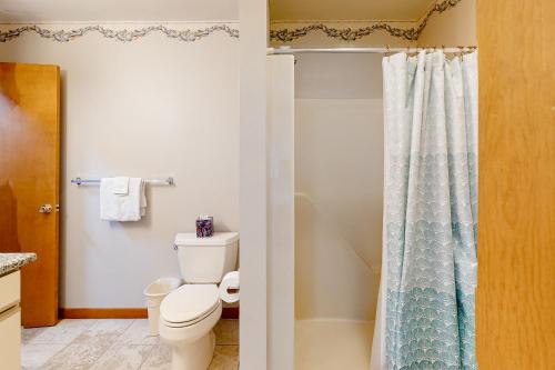 a bathroom with a toilet and a shower curtain at Gull's Nest --- 39638 S Gulls Way Ct in Bethany Beach
