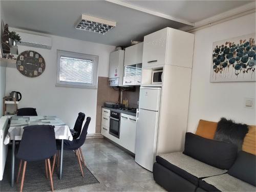 a kitchen and dining room with a table and chairs at Apartments Martina in Osijek