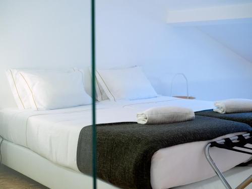 two beds in a room with blue lighting at Apartamentos Premium Familiares - Loft Guesthouse BeMyGuest Viseu in Viseu